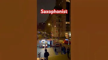 A street performer plays saxophone outside the Met Museum on Fifth Avenue in NYC